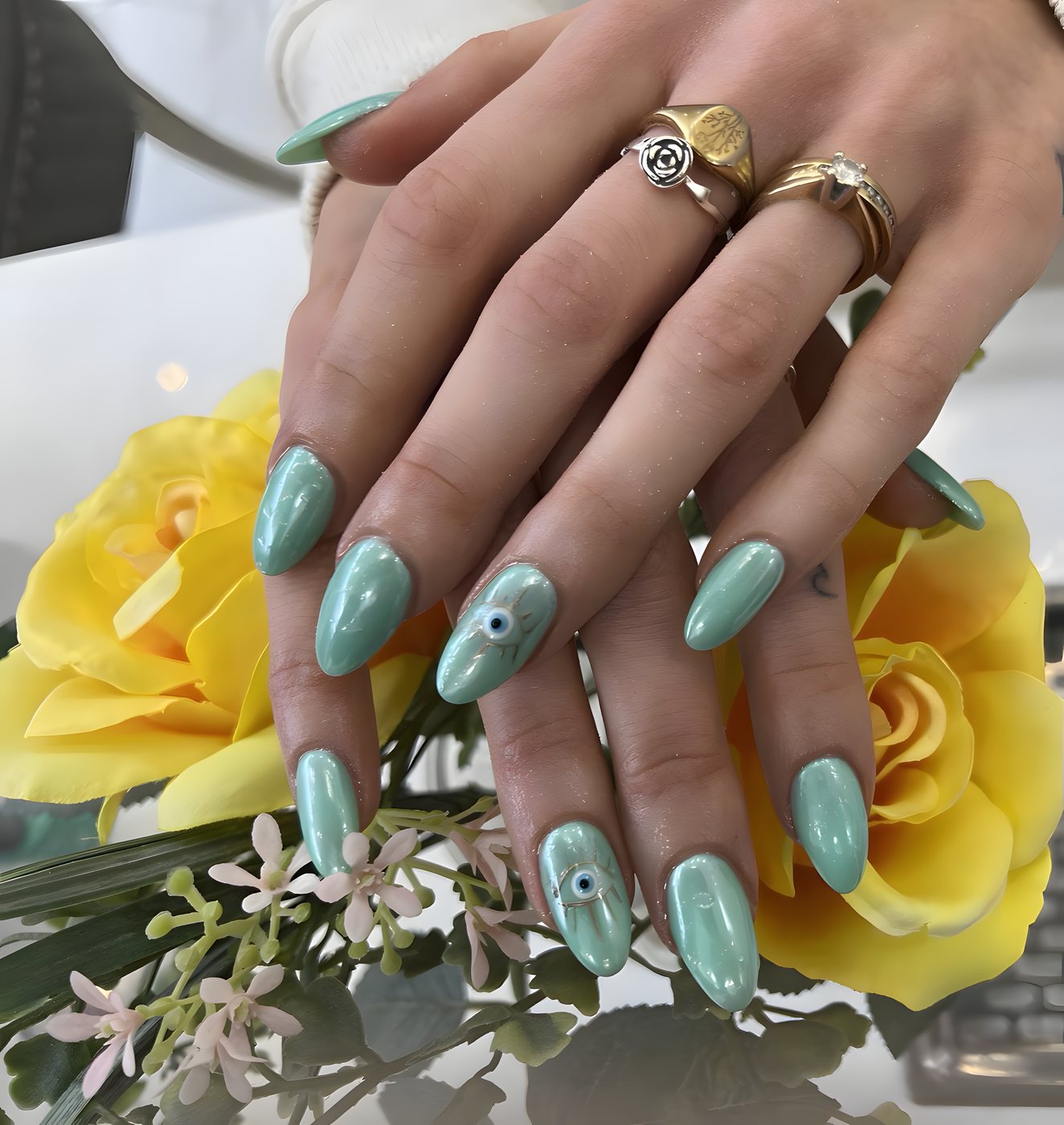 Mint green nails with a chrome finish